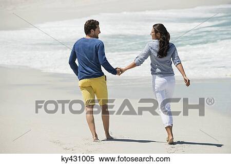 Couple enjoying on the beach View Large Photo Image Stock Photography - Couple enjoying on the beach. Fotosearch