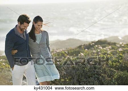 Couple walking on the beach View Large Photo Image Picture - Couple walking on the beach. Fotosearch
