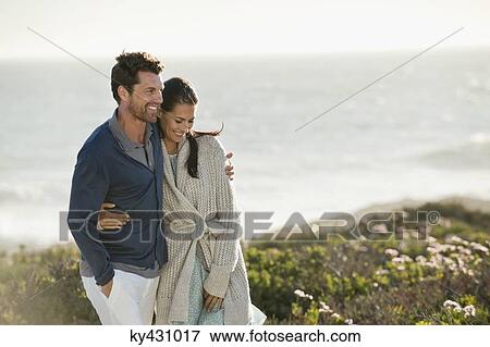 Couple walking on the beach View Large Photo Image Stock Photo - Couple walking on the beach. Fotosearch
