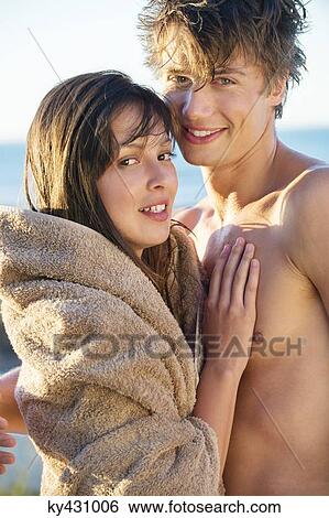 Stock Photograph - Portrait of a romantic couple on the beach. Fotosearch