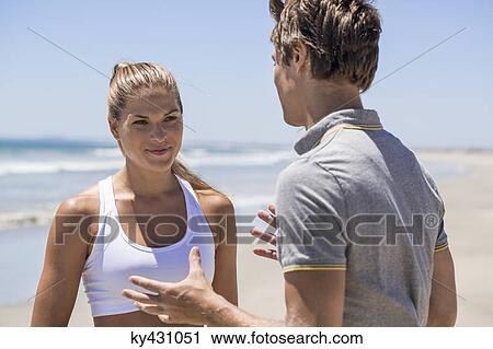 Woman talking to her coach on the beach View Large Photo Image Stock Image - Woman talking to her coach on the beach. Fotosearch