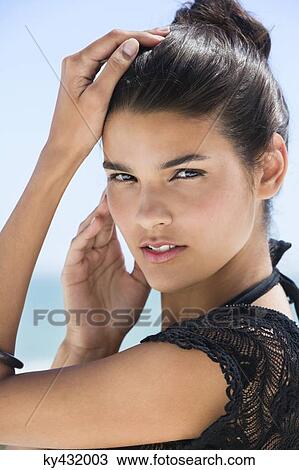 Portrait of a beautiful woman posing on the beach View Large Photo Image Stock Image - Portrait of a beautiful woman posing on the beach. Fotosearch