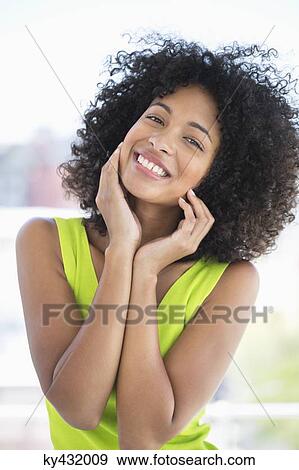 Portrait of a smiling woman posing View Large Photo Image Stock Photo - Portrait of a smiling woman posing. Fotosearch