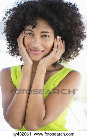 Stock Image - Portrait of a woman smiling. Fotosearch