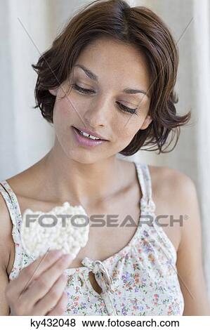 Stock Photo - Woman holding a rice cake. Fotosearch