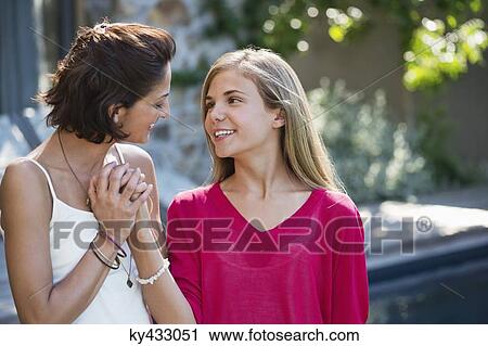 Close-up of a woman and her daughter smiling together View Large Photo Image Stock Image - Close-up of a woman and her daughter smiling together. Fotosearch