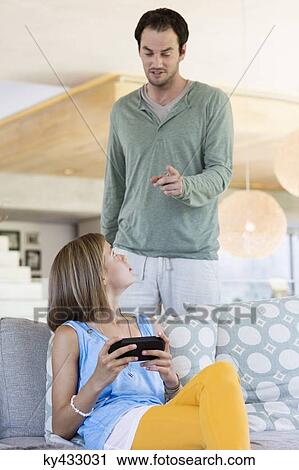 Man scolding his daughter for playing video game View Large Photo Image Stock Image - Man scolding his daughter for playing video game. Fotosearch