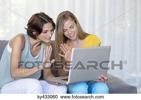 Mother and daughter chatting on a laptop View Large Photo Image Stock Image - Mother and daughter chatting on a laptop. Fotosearch