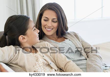 Mother and daughter smiling at each other View Large Photo Image Stock Photo - Mother and daughter smiling at each other. Fotosearch
