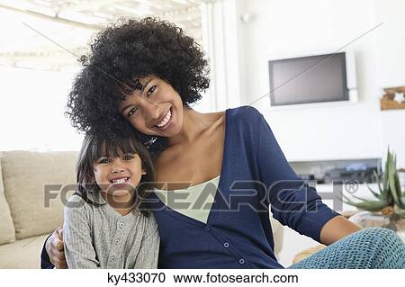 Portrait of a woman and her daughter smiling View Large Photo Image Stock Image - Portrait of a woman and her daughter smiling. Fotosearch