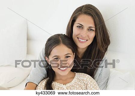 Portrait of a woman and her daughter smiling View Large Photo Image Stock Photo - Portrait of a woman and her daughter smiling. Fotosearch