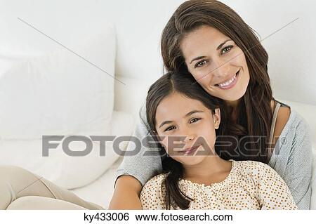 Portrait of a woman and her daughter smiling View Large Photo Image Stock Photograph - Portrait of a woman and her daughter smiling. Fotosearch