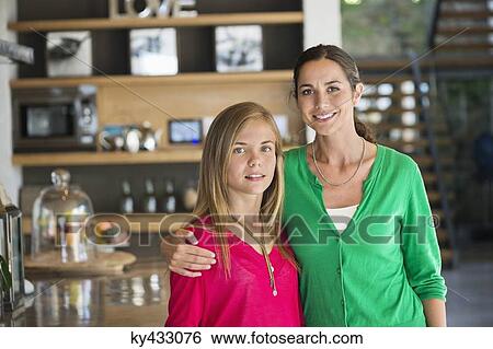 Portrait of a woman smiling with her daughter at home View Large Photo Image Stock Photograph - Portrait of a woman smiling with her daughter at home. Fotosearch