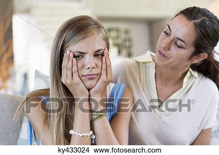Woman persuading her upset daughter at home View Large Photo Image Picture - Woman persuading her upset daughter at home. Fotosearch