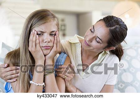 Woman persuading her upset daughter at home View Large Photo Image Stock Photo - Woman persuading her upset daughter at home. Fotosearch