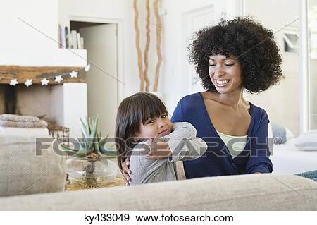 Stock Photo - Woman smiling at her daughter. Fotosearch