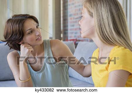Woman talking to her daughter View Large Photo Image Stock Image - Woman talking to her daughter. Fotosearch