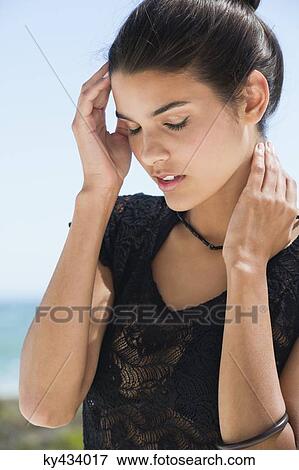 Stock Photo - Beautiful woman posing on the beach. Fotosearch