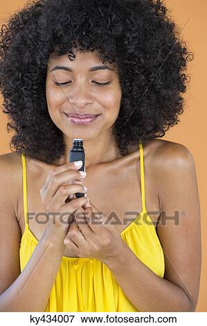 Close-up of a woman smelling scent View Large Photo Image Stock Photo - Close-up of a woman smelling scent. Fotosearch