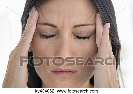 Close-up of a woman suffering from a headache View Large Photo Image Stock Image - Close-up of a woman suffering from a headache. Fotosearch