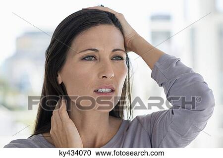 Close-up of a woman suffering from a headache View Large Photo Image Stock Image - Close-up of a woman suffering from a headache. Fotosearch