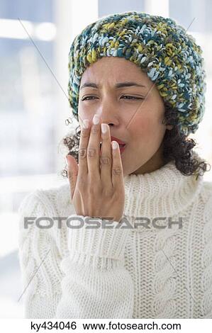 Close-up of a woman suffering from cold View Large Photo Image Stock Photograph - Close-up of a woman suffering from cold. Fotosearch