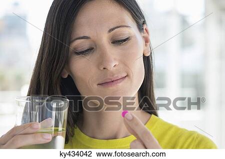 Close-up of a woman taking medicine View Large Photo Image Stock Image - Close-up of a woman taking medicine. Fotosearch