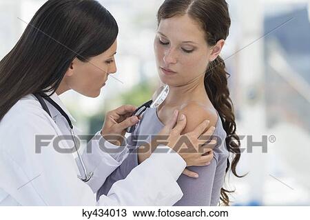 Dermatologist using magnifying glass to examine woman's skin View Large Photo Image Stock Image - Dermatologist using magnifying glass to examine woman's skin. Fotosearch