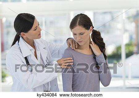 Female doctor examining a patient View Large Photo Image Picture - Female doctor examining a patient. Fotosearch