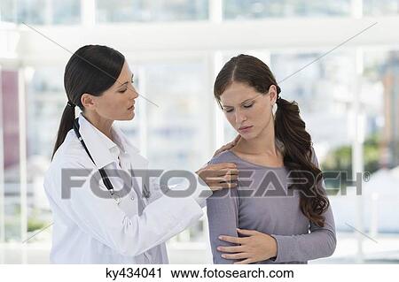 Female doctor examining a patient View Large Photo Image Stock Image - Female doctor examining a patient. Fotosearch