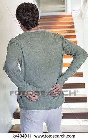 Stock Image - Man suffering from backache. Fotosearch