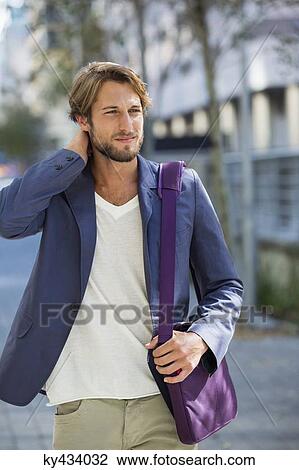 Man walking on a street View Large Photo Image Stock Image - Man walking on a street. Fotosearch