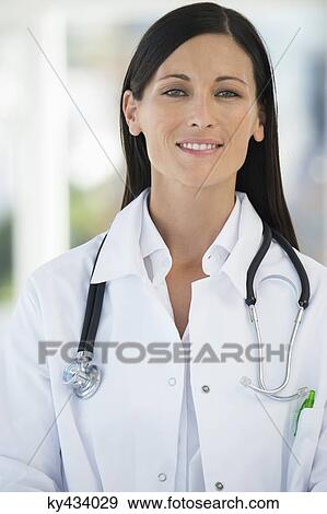Portrait of a female doctor smiling View Large Photo Image Stock Photo - Portrait of a female doctor smiling. Fotosearch