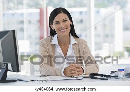 Portrait of a smiling receptionist in a doctor's office View Large Photo Image Picture - Portrait of a smiling receptionist in a doctor's office. Fotosearch