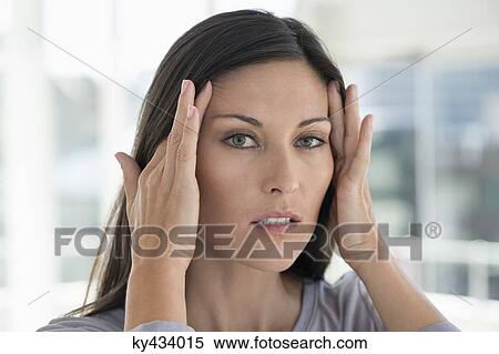 Portrait of a woman suffering from a headache View Large Photo Image Stock Photography - Portrait of a woman suffering from a headache. Fotosearch