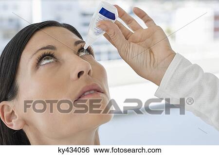 Woman applying eye drops into eye View Large Photo Image Stock Photograph - Woman applying eye drops into eye. Fotosearch
