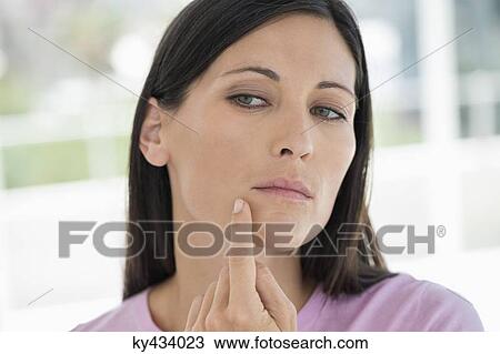 Woman checking wrinkles on her face View Large Photo Image Stock Image - Woman checking wrinkles on her face. Fotosearch