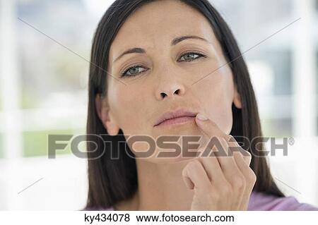 Woman checking wrinkles on her face View Large Photo Image Stock Photo - Woman checking wrinkles on her face. Fotosearch