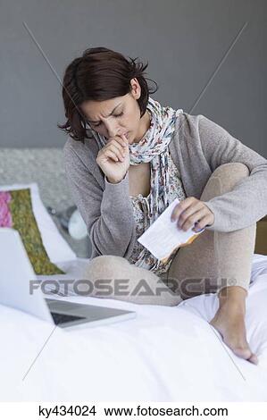 Picture - Woman looking upset while using a laptop. Fotosearch