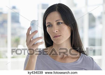 Woman reading a digital thermometer View Large Photo Image Stock Photo - Woman reading a digital thermometer. Fotosearch