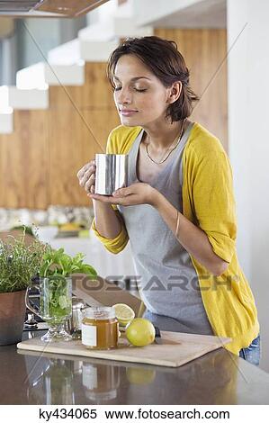 Stock Photography - Woman smelling herbal tea. Fotosearch