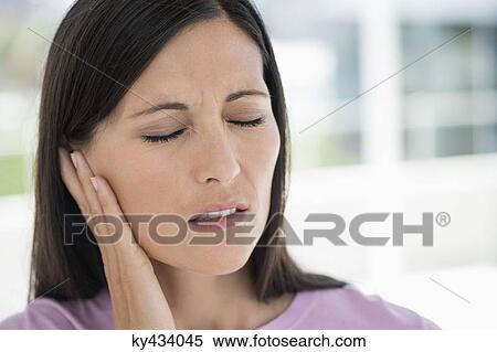Woman suffering from an ear ache View Large Photo Image Stock Photography - Woman suffering from an ear ache. Fotosearch