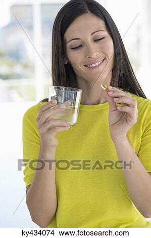 Woman taking medicine View Large Photo Image Picture - Woman taking medicine. Fotosearch