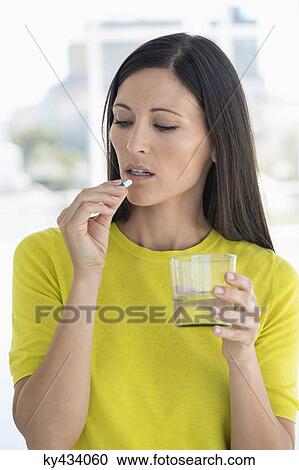Woman taking medicine View Large Photo Image Stock Image - Woman taking medicine. Fotosearch