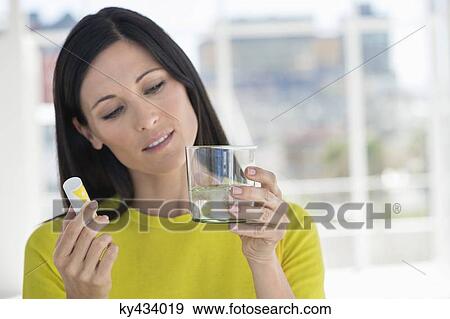 Stock Photo - Woman taking medicine. Fotosearch