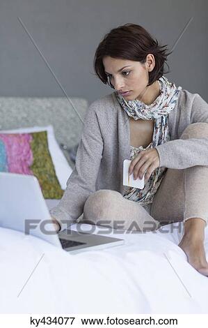 Woman working on a laptop and looking upset View Large Photo Image Stock Photo - Woman working on a laptop and looking upset. Fotosearch