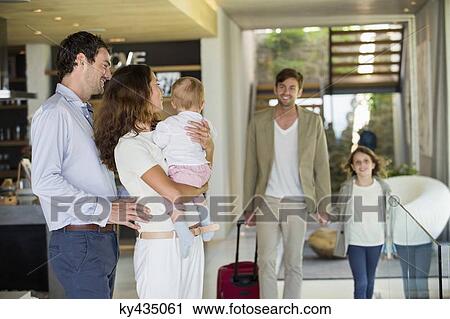 Couple looking at their friend arriving from holiday View Large Photo Image Stock Image - Couple looking at their friend arriving from holiday. Fotosearch