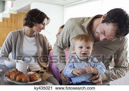 Family having breakfast at a kitchen counter View Large Photo Image Stock Image - Family having breakfast at a kitchen counter. Fotosearch