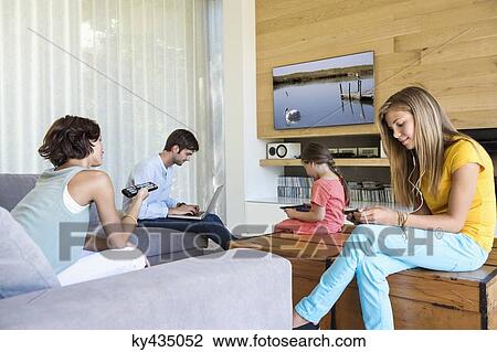 Family using electronics gadgets View Large Photo Image Stock Image - Family using electronics gadgets. Fotosearch