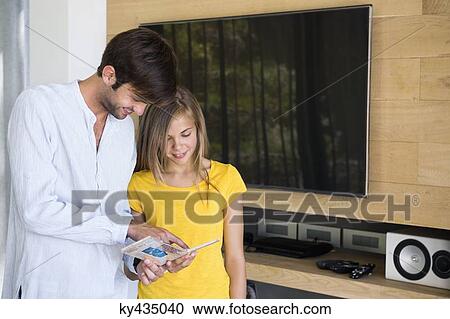 Man and his daughter looking at a CD View Large Photo Image Stock Image - Man and his daughter looking at a CD. Fotosearch